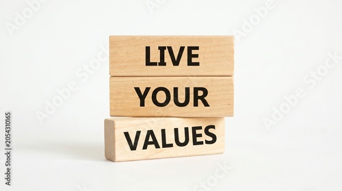 Wooden blocks spell live your values on a white surface with ample copy space.