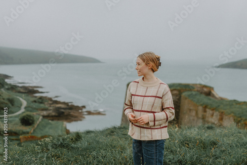 Female Traveler Enjoying Coastal View in County Cork, Ireland