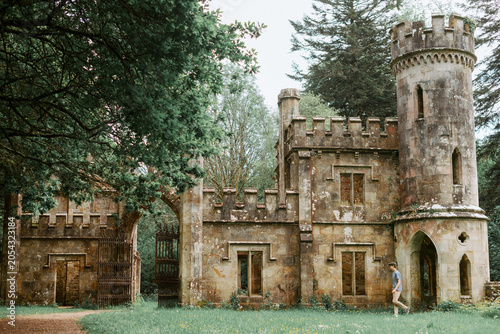 Man Walking Through Historic Ballysaggartmore Towers in County Waterford, Ireland