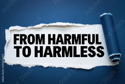 From harmful to harmless text appearing behind torn dark blue paper