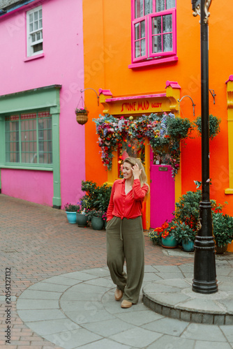 Woman Traveling Along Colorful Street in Kinsale Ireland