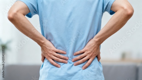 Person holding back in pain
