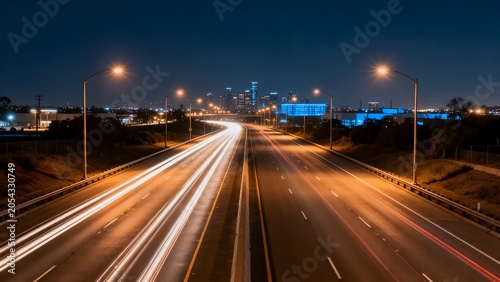 Nighttime highway with city skyline