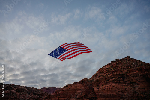 Giant American Flag Hanging Between Red Rock Desert Cliffs at Sunset in Utah to Celebrate the Patriotic America 250 Celebration for 4th of July 05