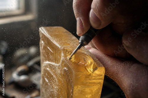 Artisan's Hands Carving Intricate Resin Sculpture