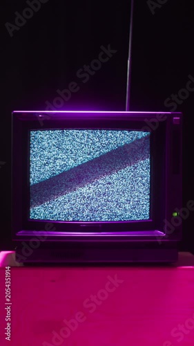 Retro TV, vintage television In a nostalgic setup, a retro TV displays grain on screen, scary halloween night device good for chroma key and green screen