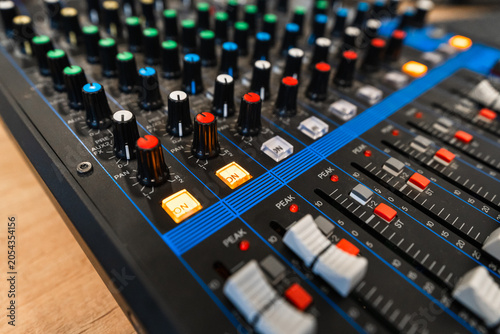 Konstfotografi Close up of professional audio mixing console with colorful knobs and faders in a recording studio, selective focus