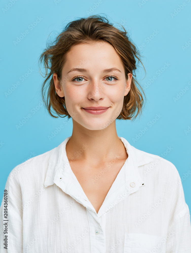 Fototapeta premium recruiter portrait with confident smile on blue background, approachable healthcare recruitment specialist in modern studio portrait, trusted professional woman representing medical branding 