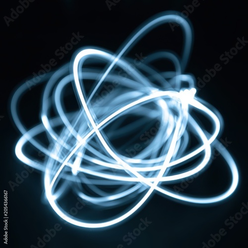 Abstract glowing light trails forming atomic orbital pattern on dark background with blue neon energy streaks