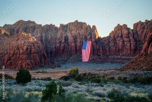 Giant American Flag Hanging Between Red Rock Desert Cliffs at Sunset in Utah to Celebrate the Patriotic America 250 Celebration for 4th of July 02