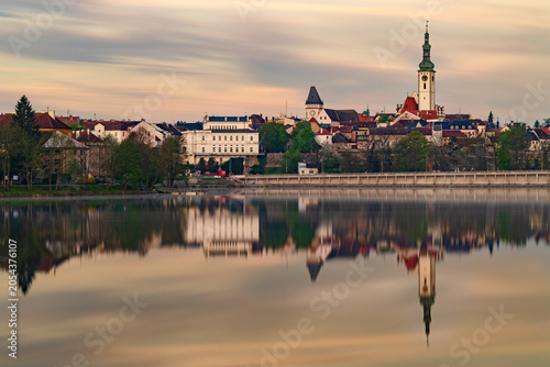 Photos Historic town of Tabor with the Church of the Transfiguration reflected in Jordan Reservoir during peaceful sunrise