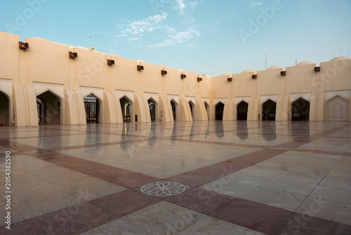 Canvas Print An empty, covered courtyard with archways and polished floors.