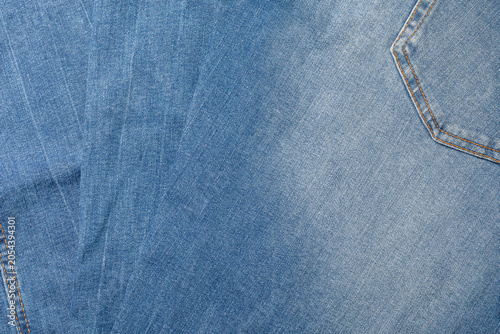 Bild auf Leinwand High-resolution texture of light blue denim fabric fanned out, featuring a classic stitched back pocket