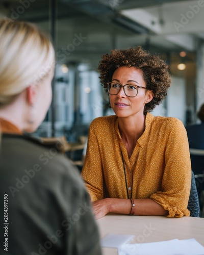 HR manager consulting employee in modern office meeting room