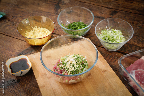Photos Making Fresh Handmade Dumpling Filling with Pork and Vegetables on Wooden Kitche