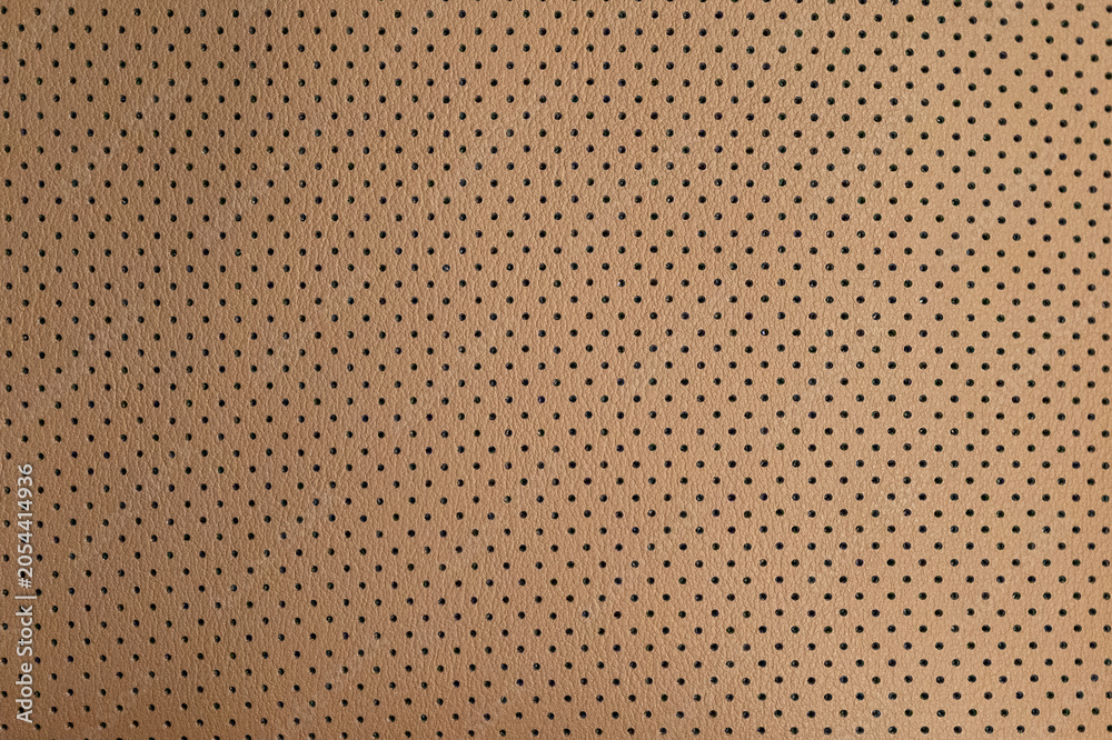 Fototapeta premium Brown perforated leather pattern creating abstract texture background