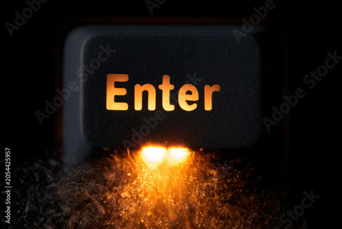 Keyboard key enter backlit glowing amber dark macro closeup plastic dust texture switch typing computer technology hardware input keycap illuminated black shadow night abstract detail surface