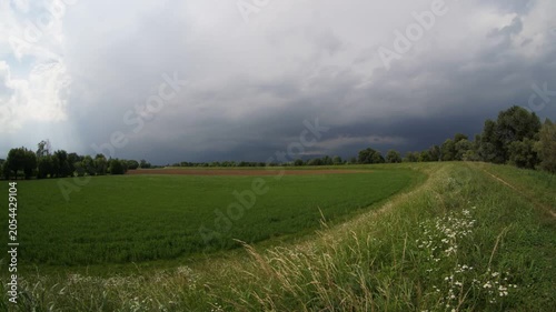 Storm Clouds and Sun Rays Over Countryside Landscape Timelapse