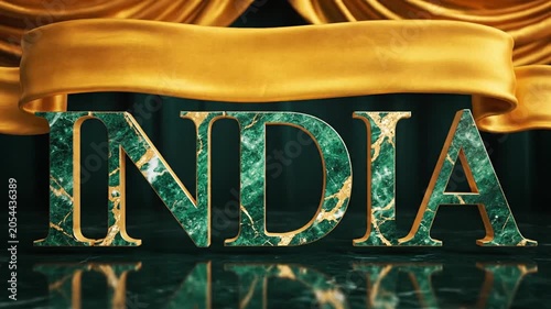 Elegant stage presentation featuring the word india with shimmering green textured letters and golden ribbons in a grand theater