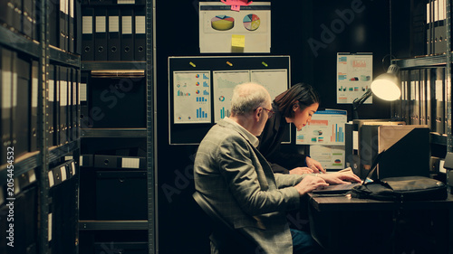 Canvas Print Law agents studying old classified information from police archives folders, looking for clues and crime trends, Partners accessing additional archived resources in incident room