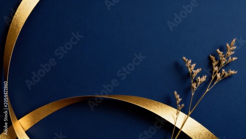Golden ribbon and dried flowers on blue