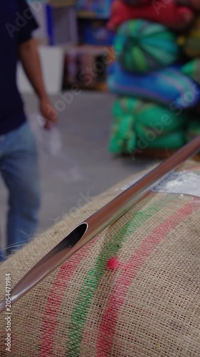 Sampling Green Coffee Beans from Burlap Sacks Using a Coffee Probe for Quality Control – Vertical Video