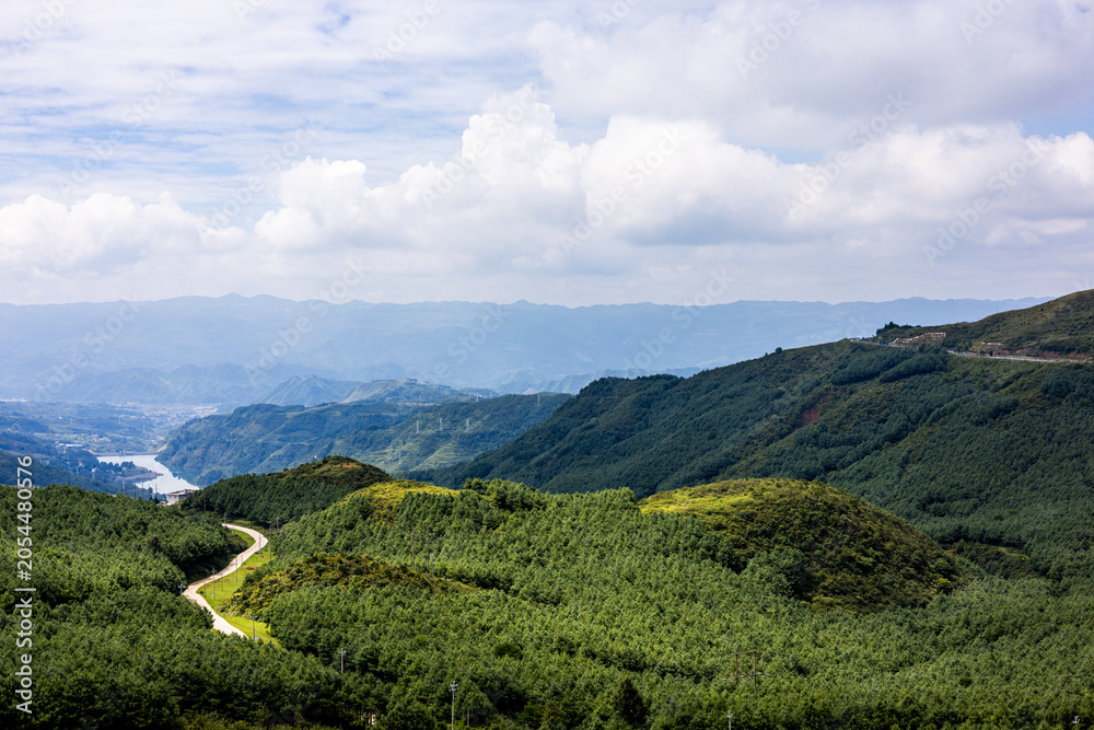 Fototapeta premium Breathtaking Mountain Landscape with Winding Trails and Forest Valley