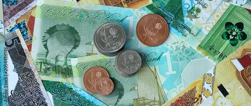 Картината върху платно Qatari riyal money bills and coins in pile