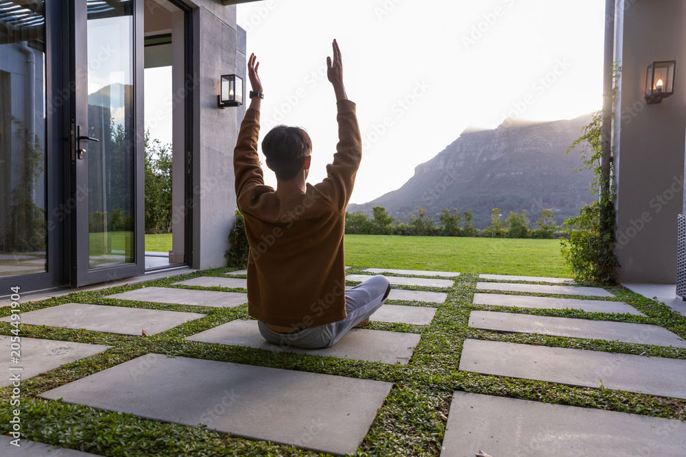 Fototapeta premium Concrete square pavers are forming grid on patio while sun is backlighting distant mountain ridge
