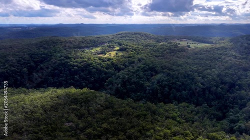 Aerial Somersby falls creek sky down to canopy waterway in Australia Central coast.