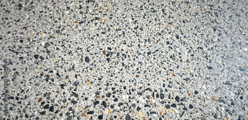 Tableau sur toile Close-up view of a textured concrete surface featuring various colored aggregate stones embedded within