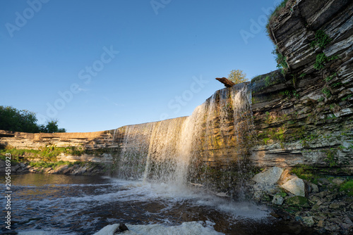Scenic waterfall in the sunset light. Jagala Waterfall.