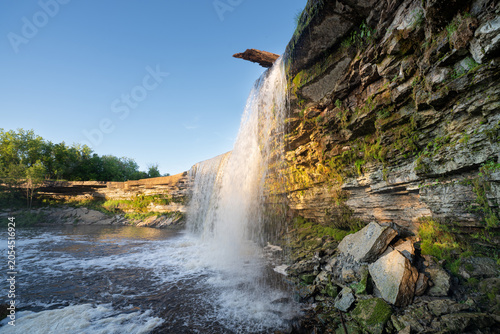 Scenic waterfall in the sunset light. Jagala Waterfall.