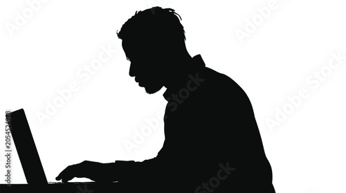 Businessman silhouetted in profile works diligently on his laptop computer while sitting against a stark white background that provides ample copy space for creative professional marketing designs.