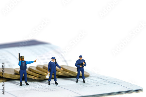 Miniature people toy figure photography. Bank account protection concept. A security officer team standing above bank account. Isolated on white background