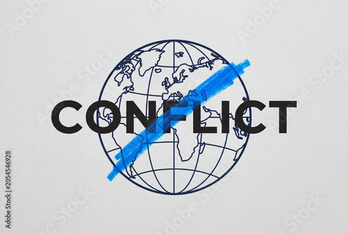 Minimalist earth globe model with the word conflict boldly crossed out by a blue marker stroke