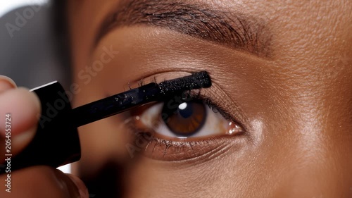 Applying Dark Mascara To Enhance Eyelashes For A Defined Beauty Look