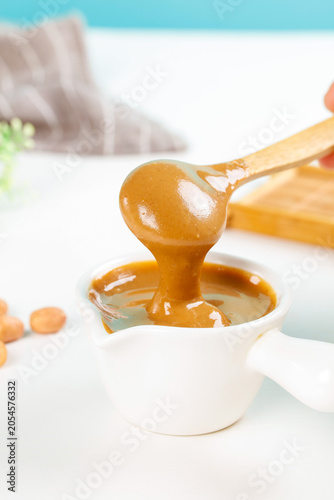 Homemade Peanut Butter Dripping from Spoon
