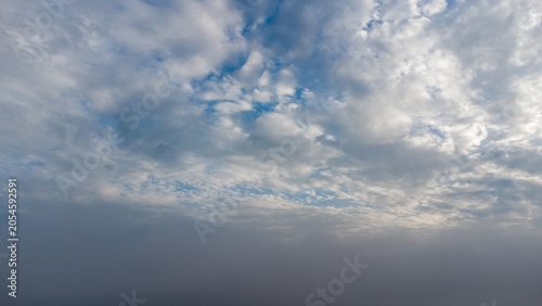 Beautiful blue sky with dramatic white cumulus clouds creating a scenic cloudscape over tropical Indonesia