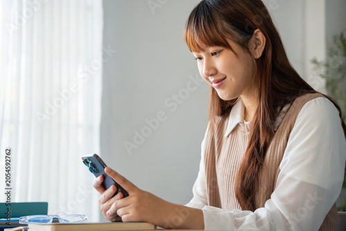 Bild auf Leinwand Student asian woman lying use smart phone in dorm room college mobile addict spending time checking news technology e-commerce