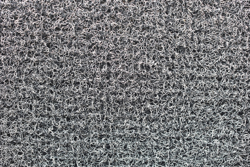 Rough, gray fibrous surface up close.