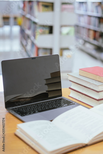 Laptop and Stack of Books in Library – Digital Education, Academic Research and Modern Learning Concept
