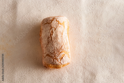 Bild auf Leinwand Freshly Baked Artisan Italian Ciabatta Bread with Slices on Textured Linen Table