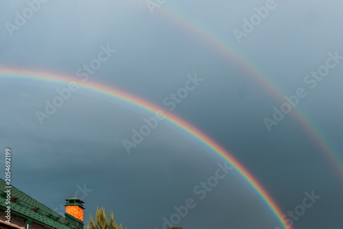 Rainbow over a country house on a summer day