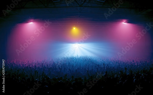Vibrant lights illuminate a cheering crowd in a dark, atmospheric concert venue