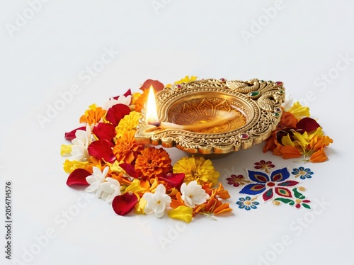 Traditional golden diya lamp with flowers isolated on white background