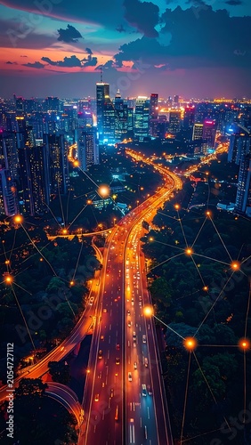 Aerial cityscape at dusk with illuminated highway and skyscrapers
