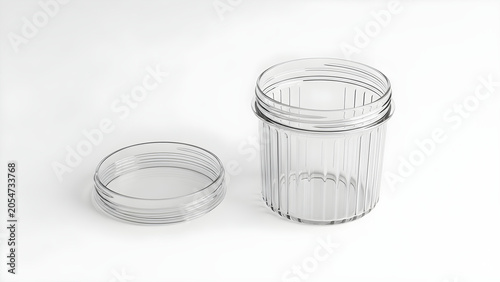 A clear glass jar with its lid off sits on a plain white surface.