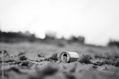 Discarded Aluminum Can on Dry Ground in Black and White