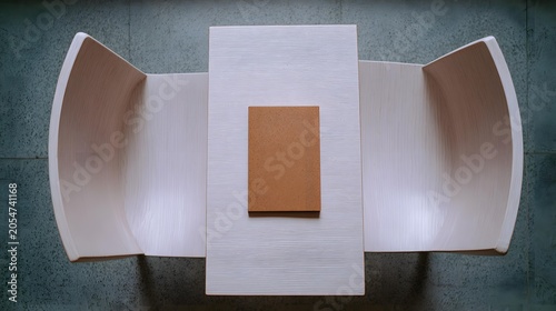 with one closed notebook placed precisely in center on clean desk